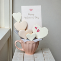 Heart-decorated cookies arranged in a gift cup