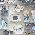 Baby boy themed decorated cookies with onesie and bottle shapes