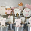 Pink hand-decorated sugar cookies for a baby girl celebration