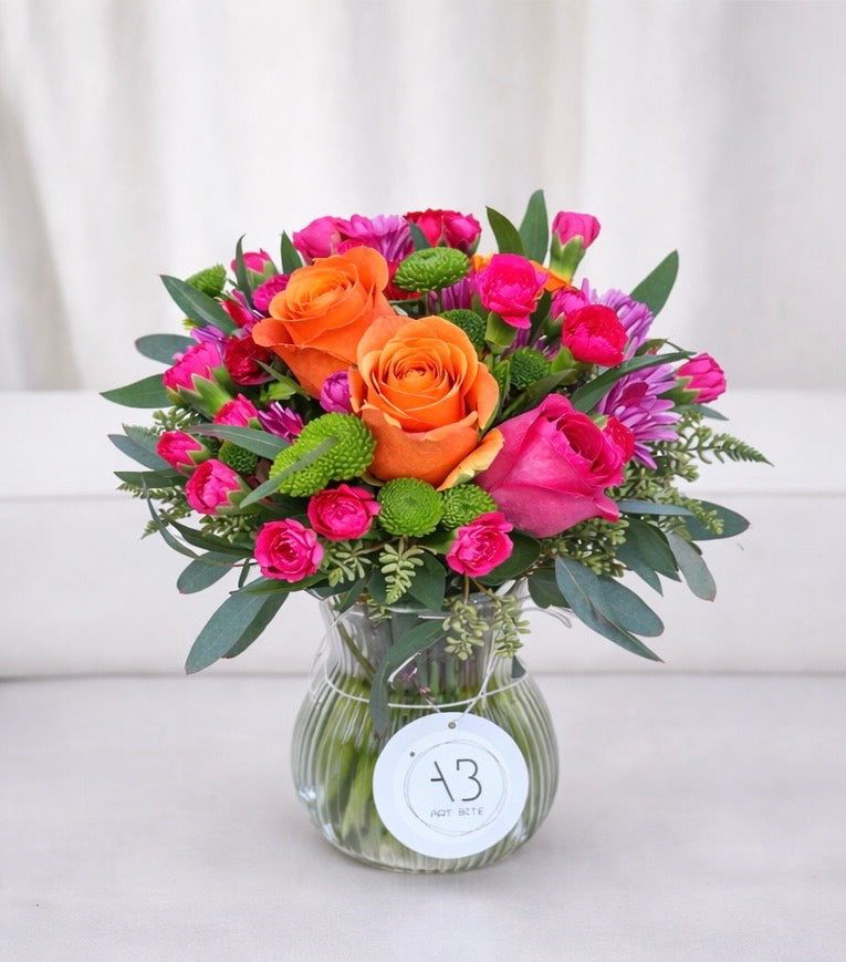 Close-up of confetti-style mixed flower arrangement in a vase