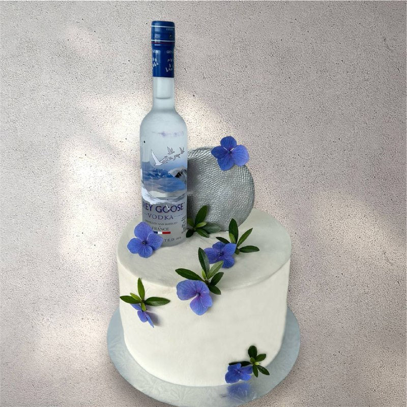 Grey and white novelty cake designed to look like a vodka bottle with black label