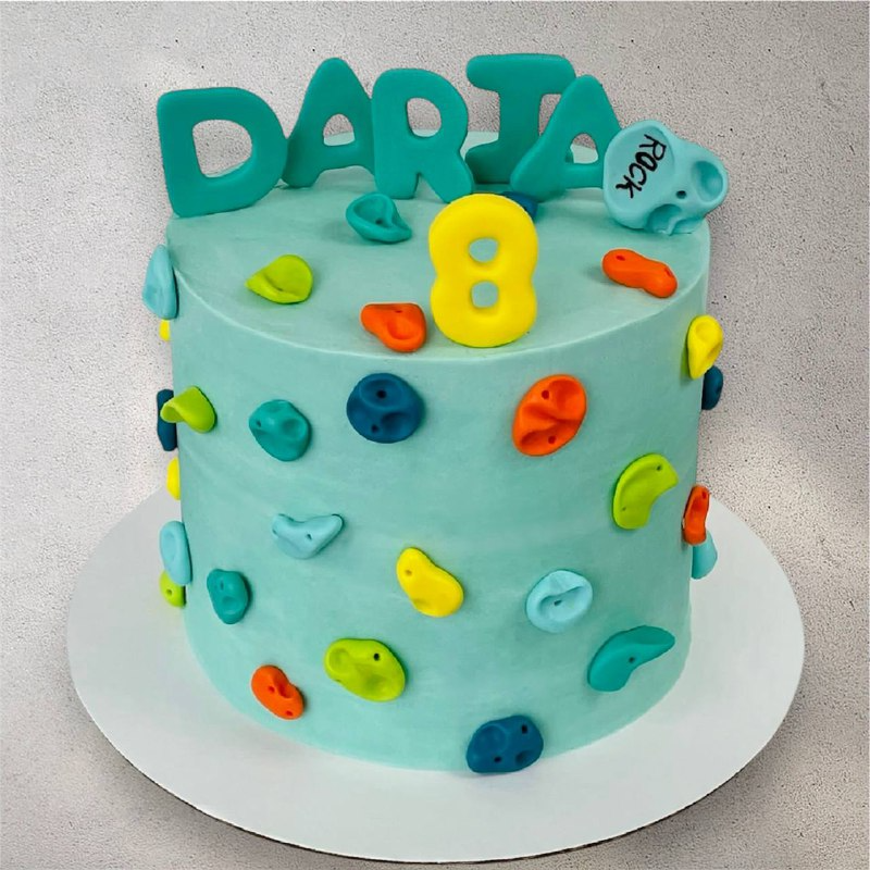 Custom cake decorated with a mountain climbing scene design