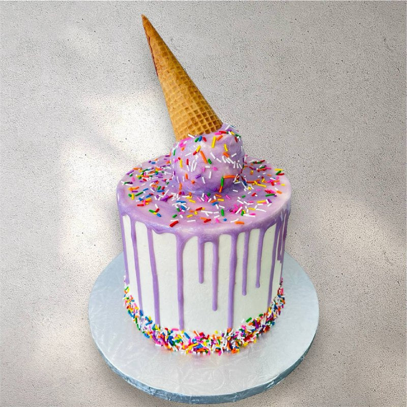 Ice cream cone shaped custom cake with colorful buttercream swirl