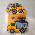 Construction-themed birthday cake with edible truck and cone decorations