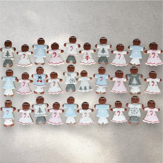 Decorated gingerbread family cookies lined up together