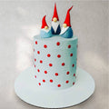 Birthday cake decorated with colorful fondant garden gnomes