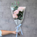 Soft pastel fresh cut flower bouquet wrapped for gifting