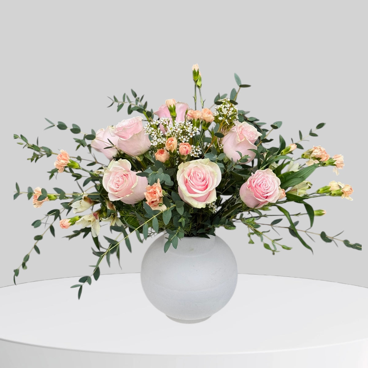 Autumn-toned flower arrangement with warm orange and rust blooms
