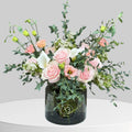 Soft white flower arrangement in a simple glass vase