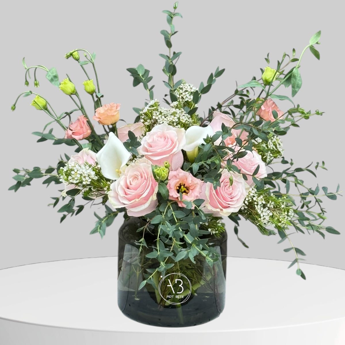 Soft white flower arrangement in a simple glass vase