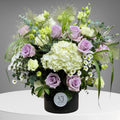Bouquet of purple flowers arranged in a glass vase
