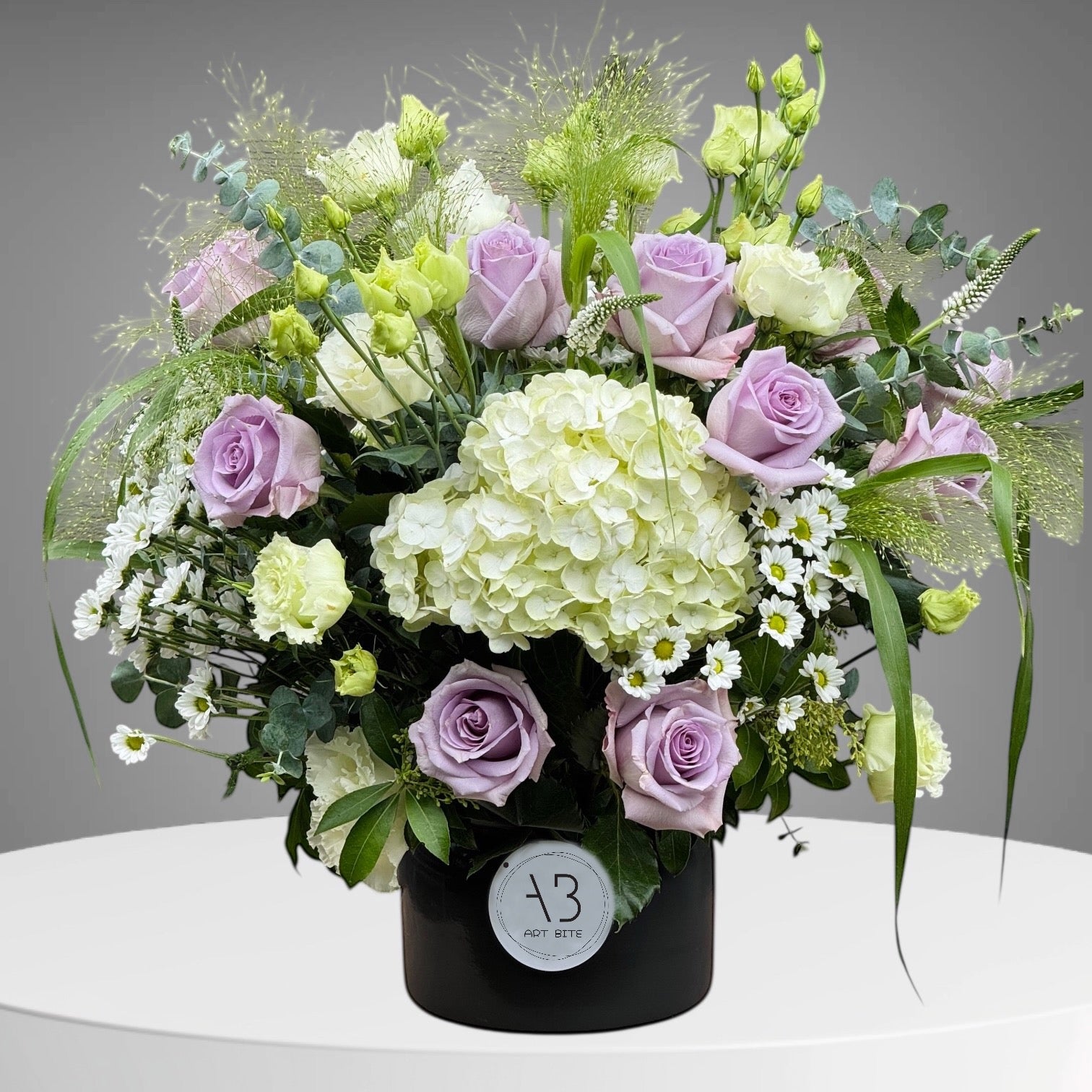 Bouquet of purple flowers arranged in a glass vase