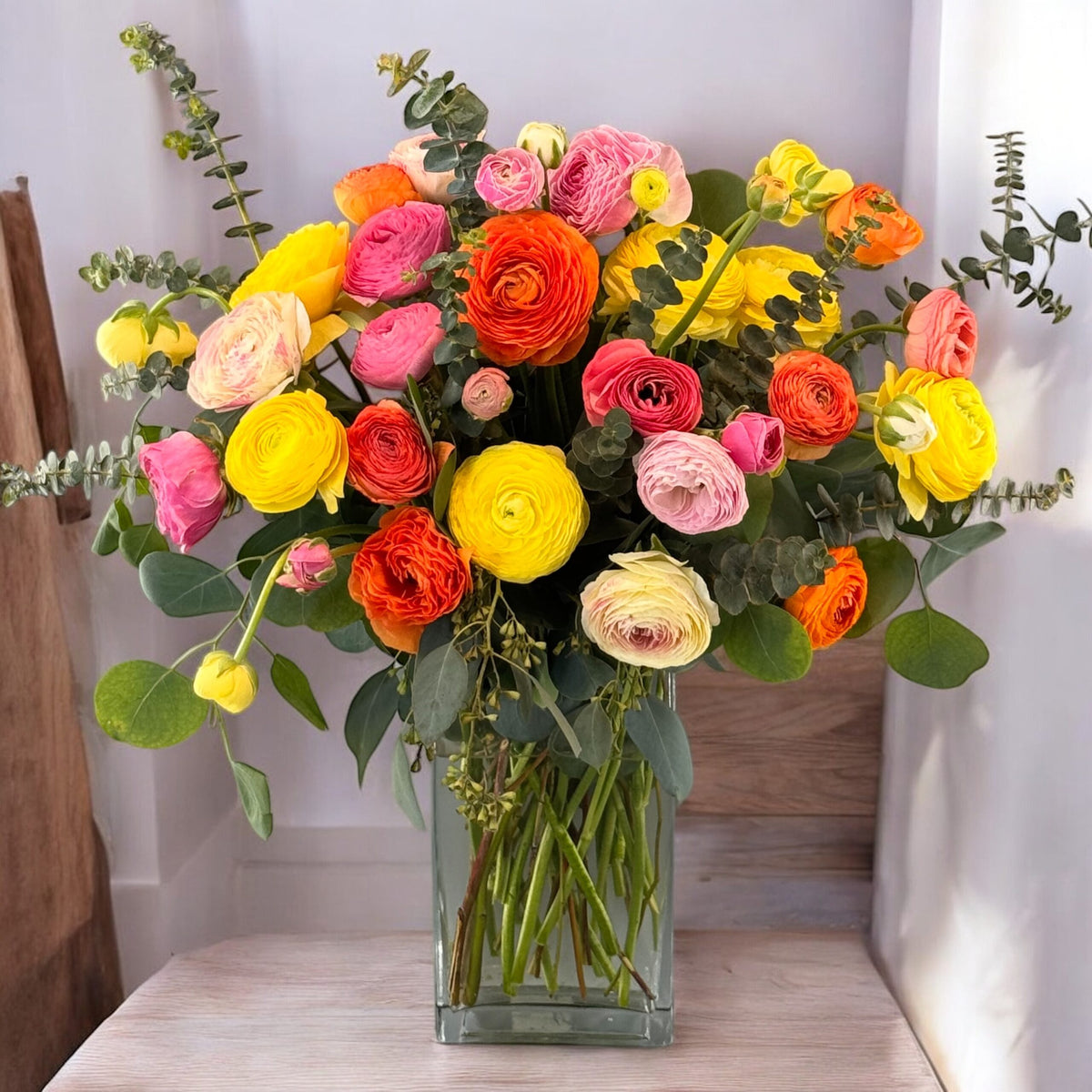 Vibrant, colourful flower vase arrangement with mixed blooms