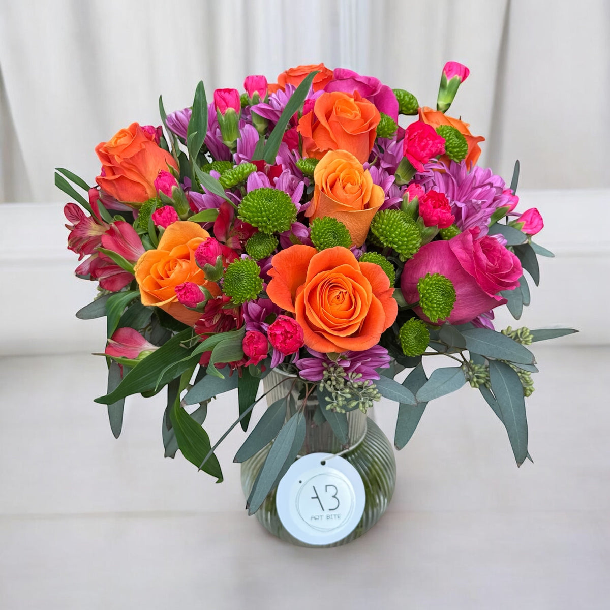 Colorful vase arrangement with mixed garden flowers and greenery