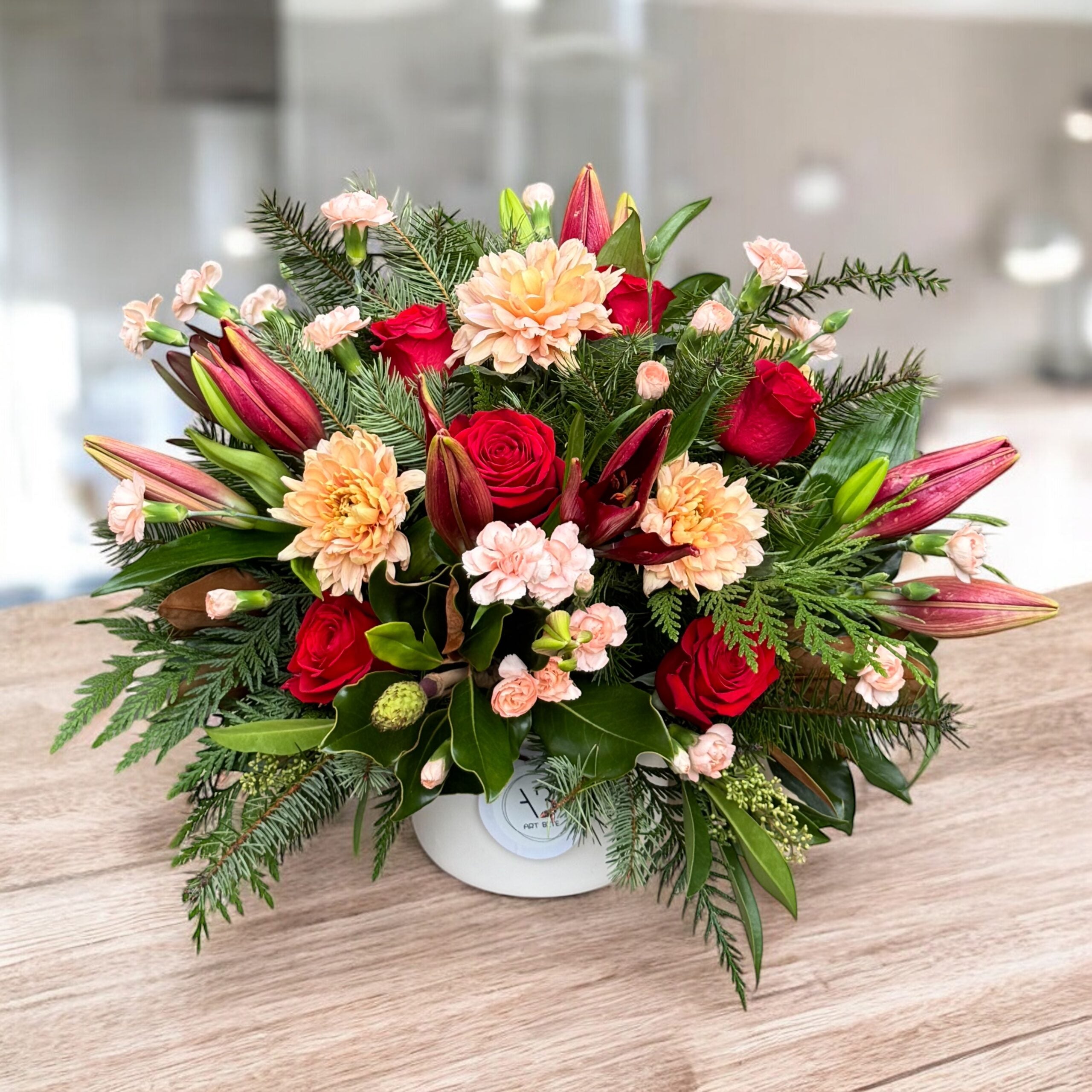 Rouge-toned flower arrangement with magnolia blooms in a vase