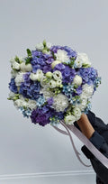 Lilac and violet flower bouquet wrapped for gifting
