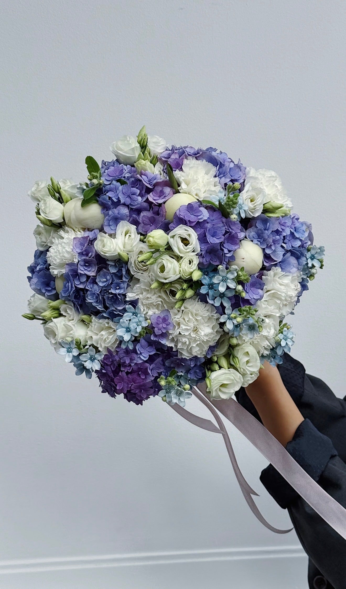 Lilac and violet flower bouquet wrapped for gifting
