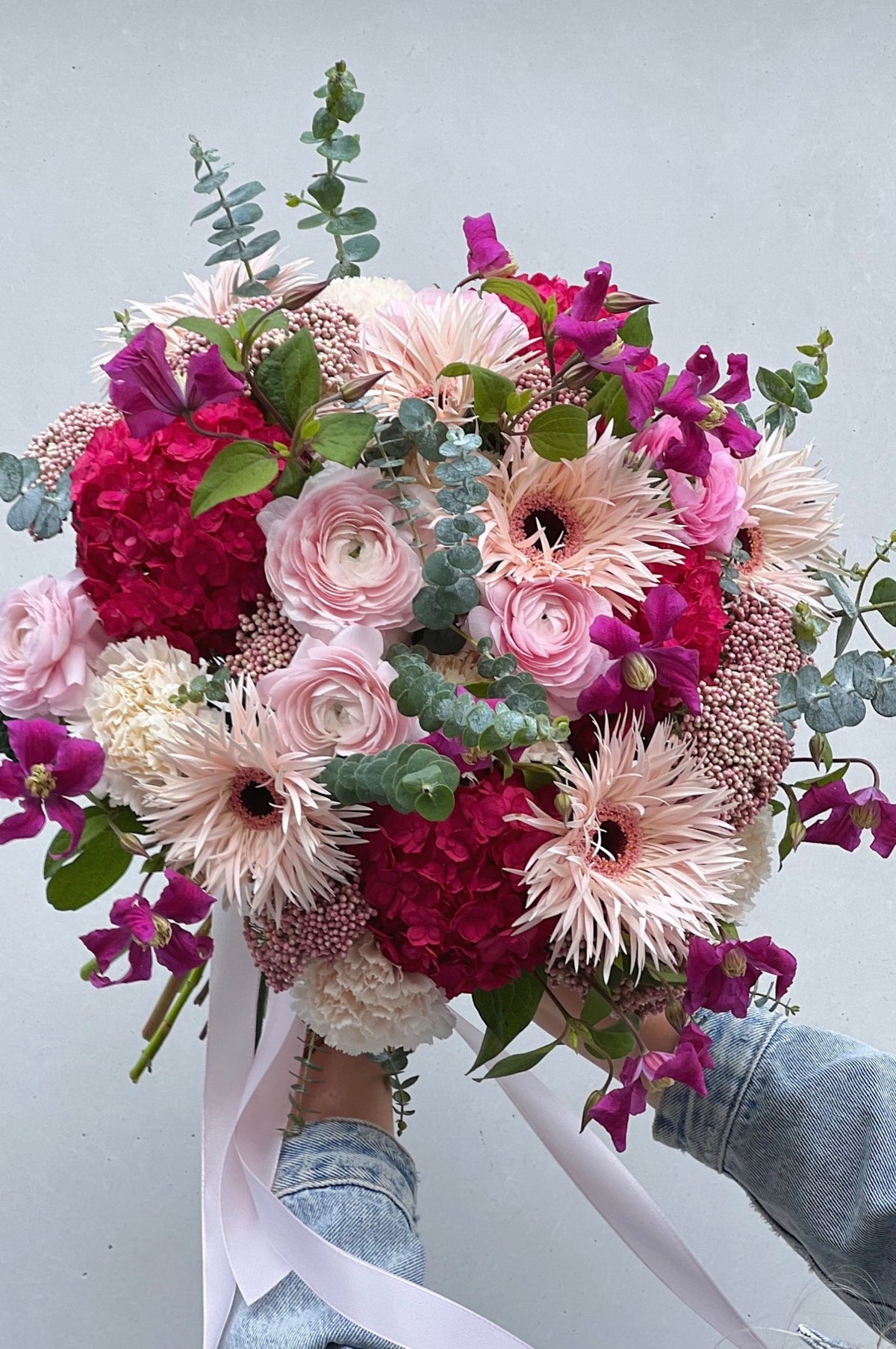 Close-up of fresh pink roses in a hand-tied bouquet