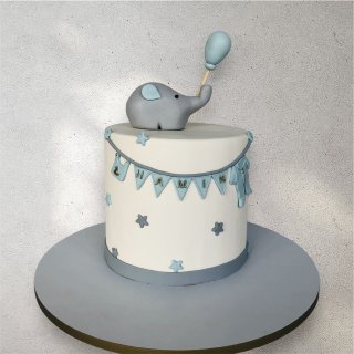 Blue-themed gift box filled with baby boy treats and decorated cookies