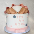 Pink baby girl gift box filled with treats and ribbon accents