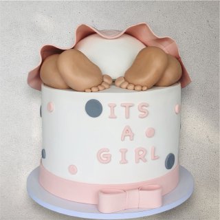 Pink baby girl gift box filled with treats and ribbon accents