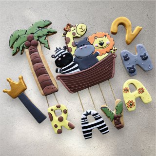 Individually decorated jungle animal cookies including lion and elephant shapes