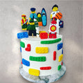 Custom birthday cake decorated to look like stacked colorful Lego bricks
