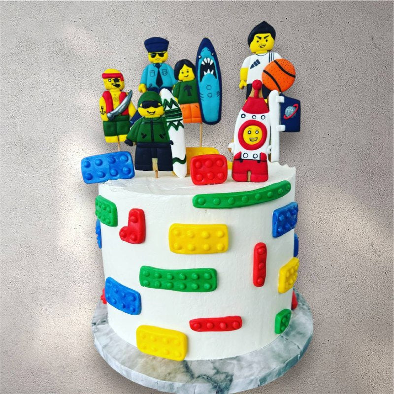 Custom birthday cake decorated to look like stacked colorful Lego bricks