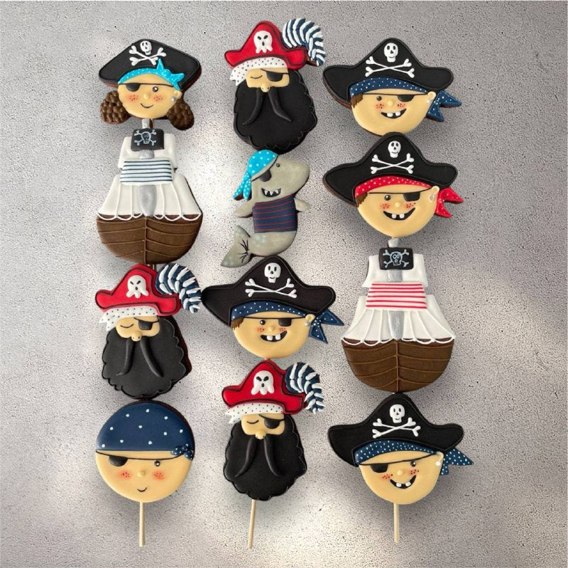Ocean-themed decorated sugar cookies with fish and wave designs