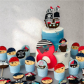Set of decorated sugar cookies shaped like pirate ships and treasure maps