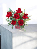 Fresh flower arrangement in a velvet-textured cube vase