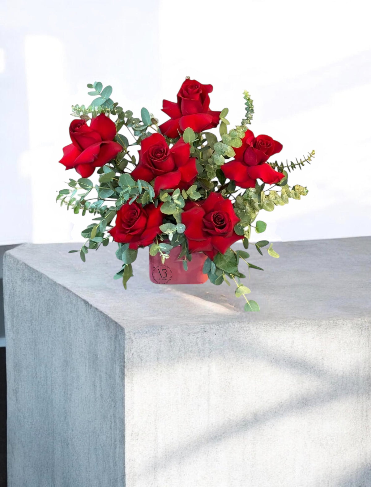 Fresh flower arrangement in a velvet-textured cube vase