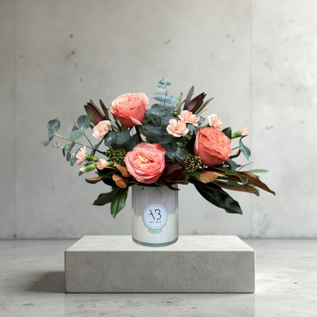 Blush pink flower vase arrangement with delicate greenery