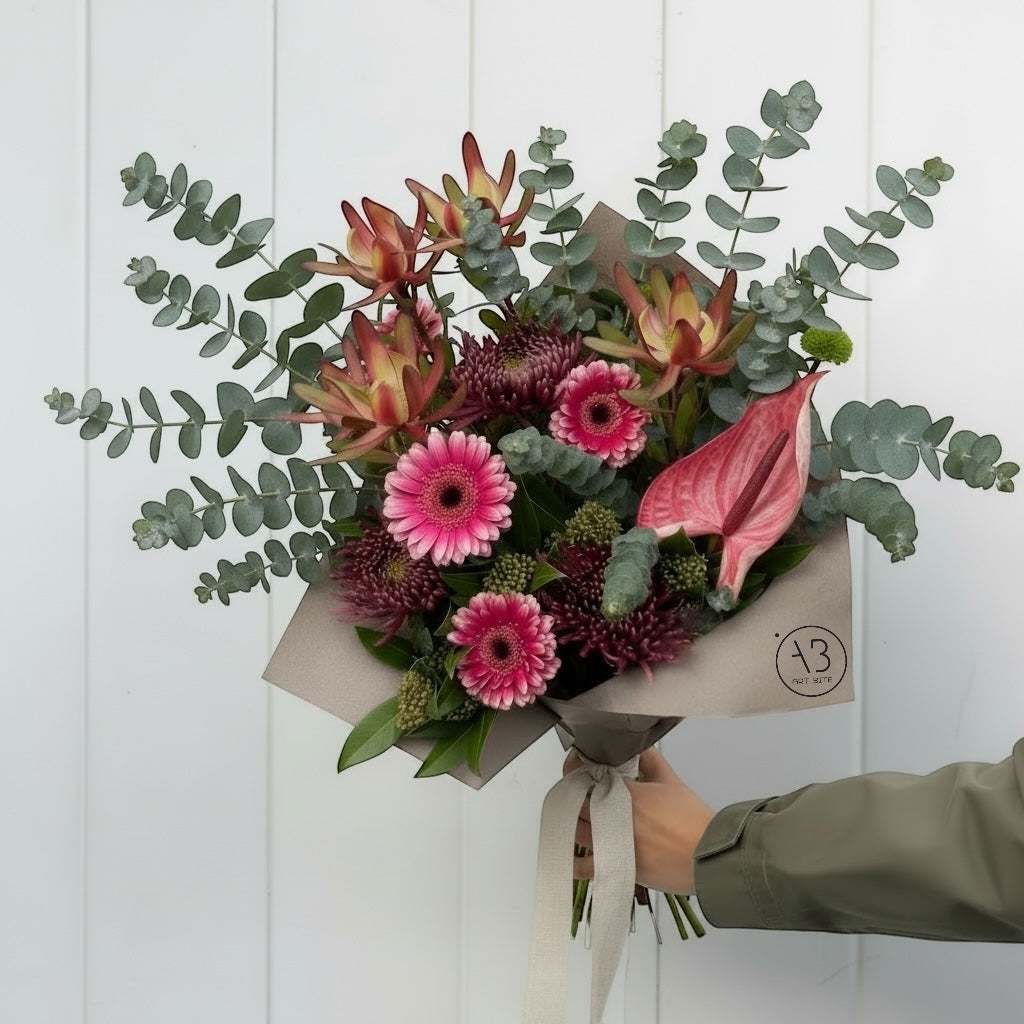 Bright magenta flower bouquet wrapped for gifting