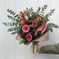 Bright magenta flower bouquet wrapped for gifting