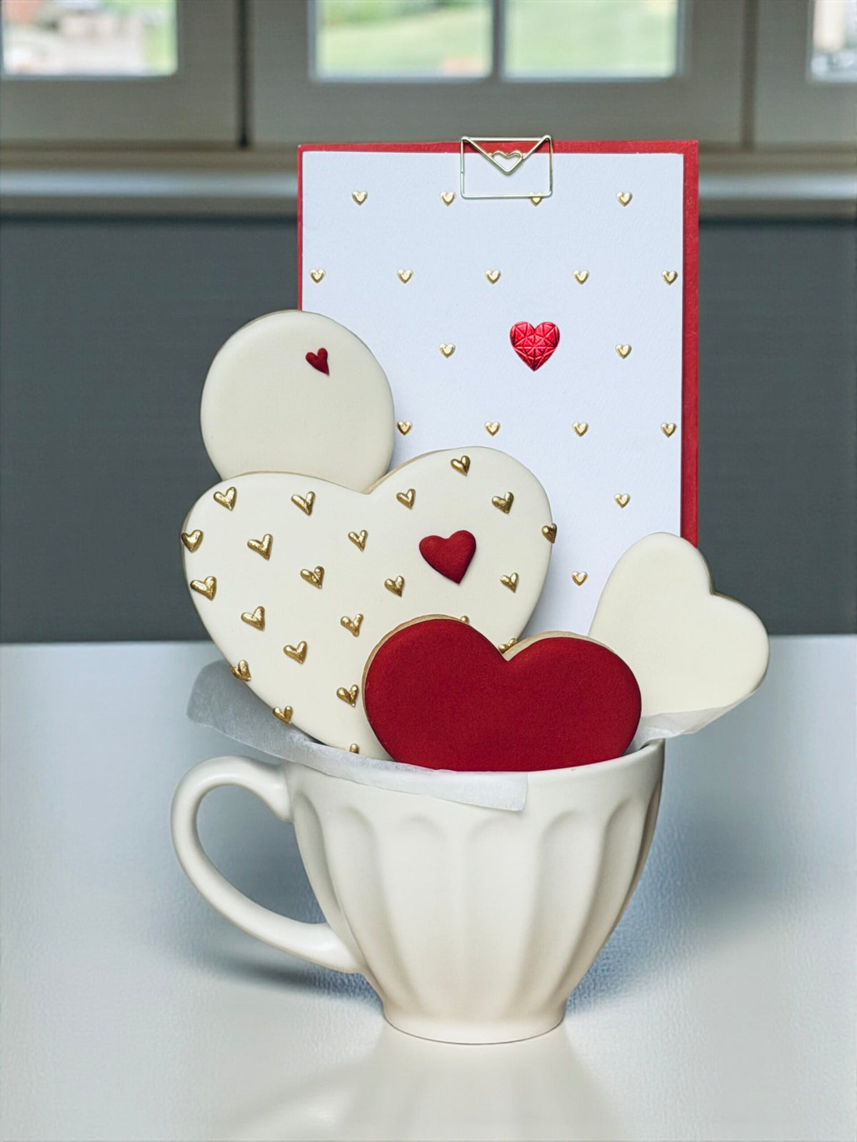 Heart-decorated cookies arranged in a gift box cup for Valentine's Day