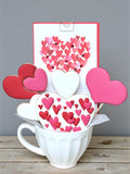 Heart-shaped decorated cookies presented in a gift box cup