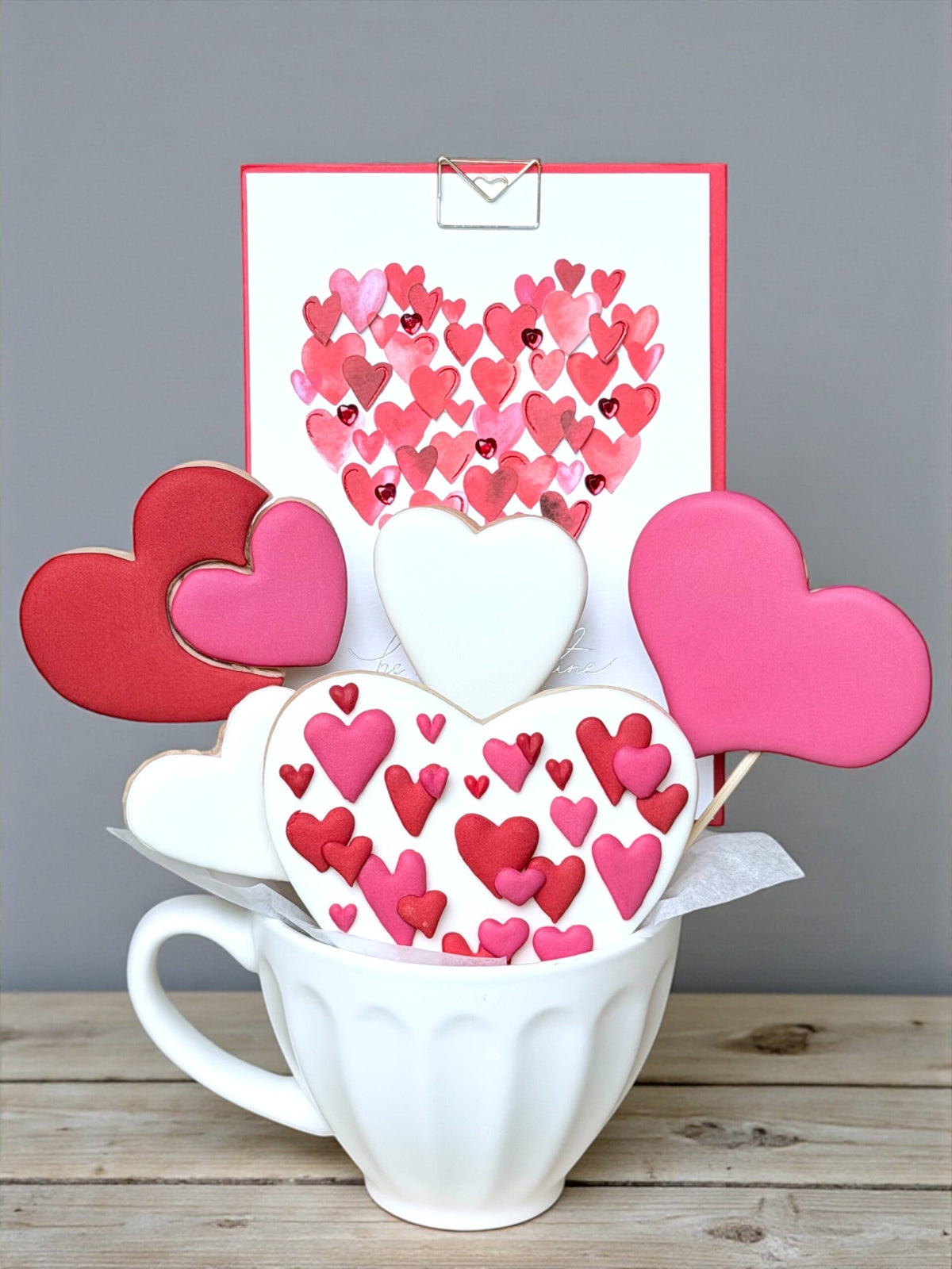 Heart-shaped decorated cookies presented in a gift box cup