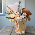 Rose vase arrangement paired with a decorative gift box