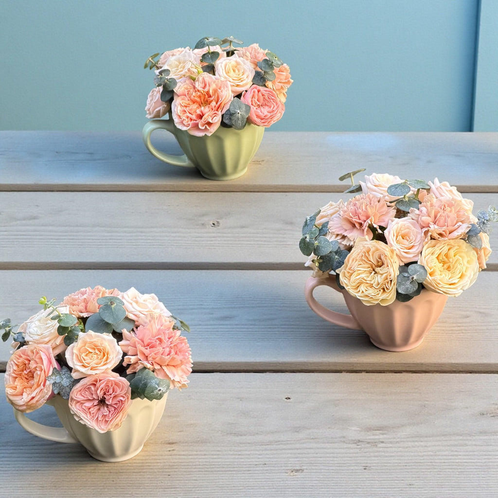 Side angle of a curated flower arrangement in a glass vase