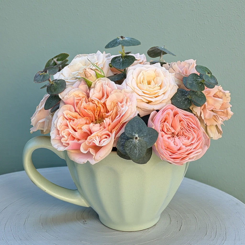 Close-up of a mixed flower vase arrangement in soft pastel tones