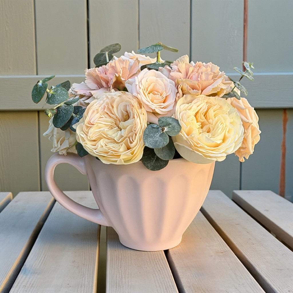 Vase arrangement of fresh flowers styled as a birthday gift