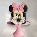 Pink Minnie Mouse-themed birthday cake with polka dot details