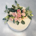 Custom cake decorated with spring garden flowers and pastel icing