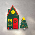 Decorated gingerbread house cookie with white icing snow on the roof