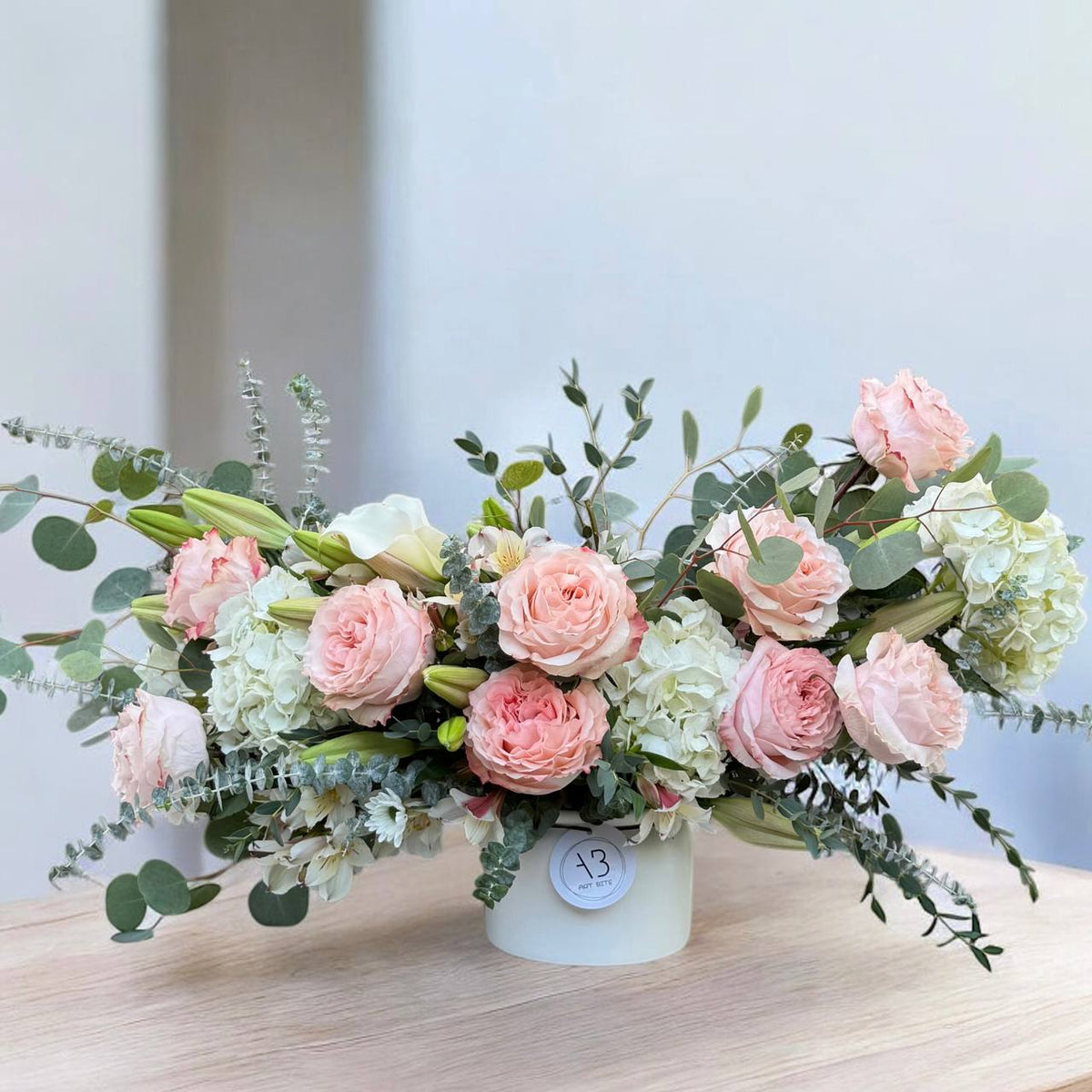 Soft pink flower vase arrangement with artistic styling