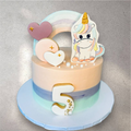 Pastel unicorn birthday cake with buttercream mane and gold horn